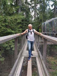 Full length of man standing on footbridge