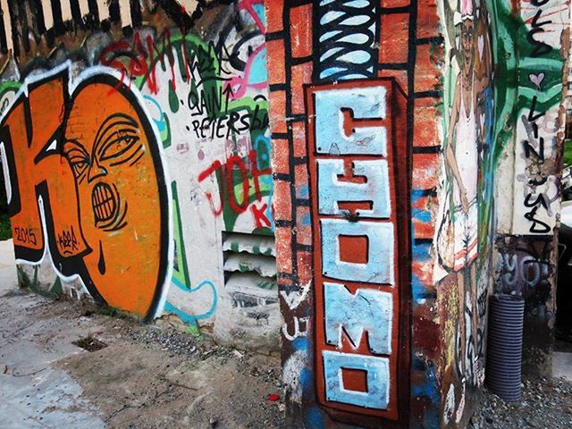 graffiti, art, art and craft, creativity, built structure, architecture, text, wall - building feature, building exterior, street art, multi colored, western script, vandalism, communication, wall, mural, day, building, human representation, outdoors