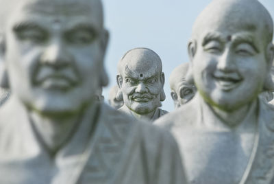 Close-up of statues against sky