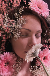 Close-up of beautiful woman smelling flowers