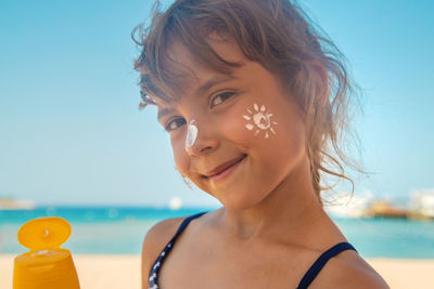 Close-up of young woman drinking straw at beach