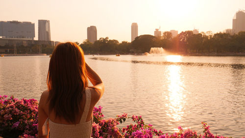 Rear view of woman looking at lake
