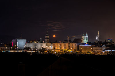 Illuminated buildings in city at night