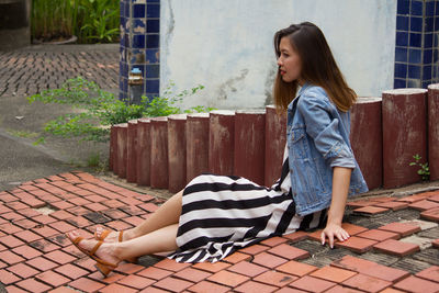 Side view of a girl looking down outdoors