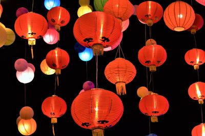 Low angle view of illuminated lanterns hanging at night