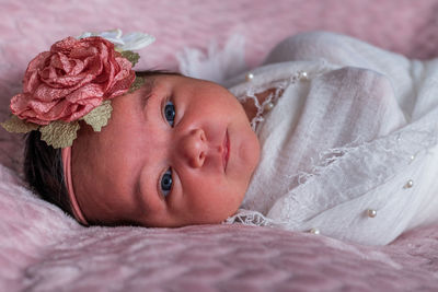 Close-up of cute baby girl looking at camera