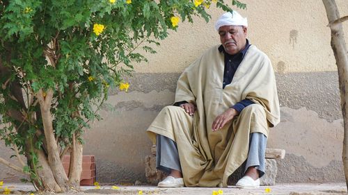 Portrait of a smiling man sitting outdoors