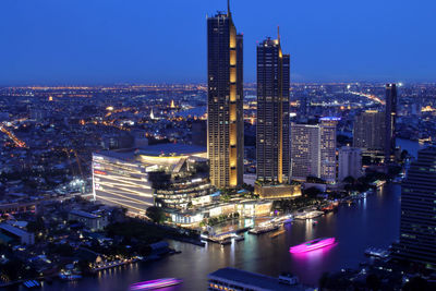 High angle view of illuminated buildings in city at night