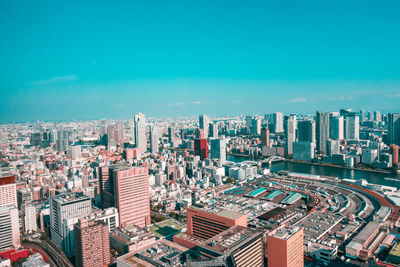 High angle view of modern buildings against blue sky