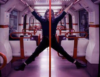 Portrait of woman stretching body in train