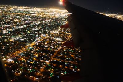 Aerial view of illuminated cityscape against sky at night