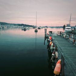 Scenic view of harbor against sky during sunset