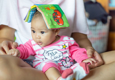 Portrait of cute baby girl at home
