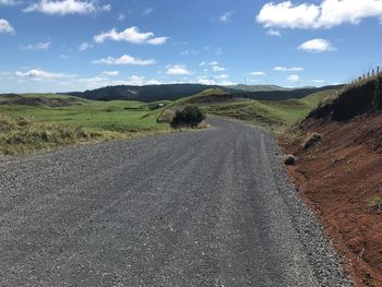 Empty road along countryside landscape