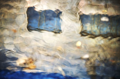 Full frame shot of glass with reflection in sea