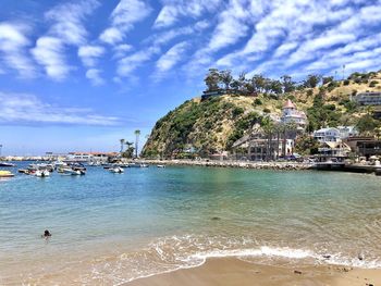 Scenic view of sea and buildings against sky