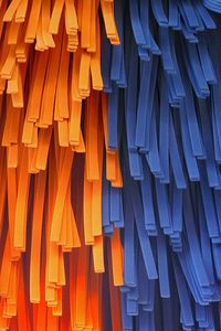 Low angle view of orange and blue foams hanging at car wash