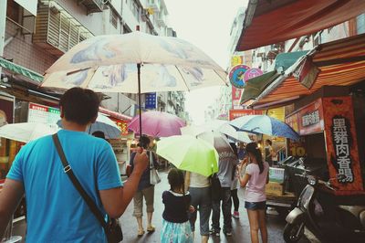 Group of people in market during rainy season