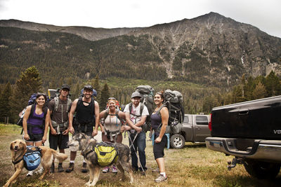 Portrait of hikers standing against mountain