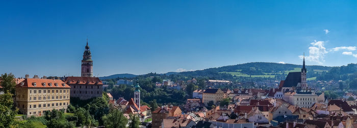 Panoramic view of buildings against blue sky