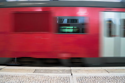 Blurred motion of train at railroad station