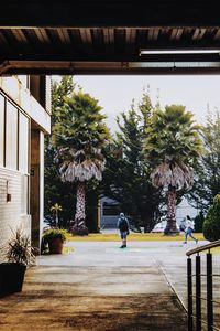 Rear view of people walking on footpath