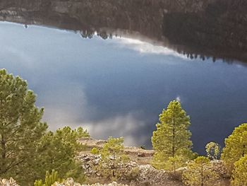 High angle view of trees by lake against sky