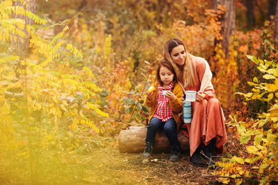 Full length of mother and daughter during autumn