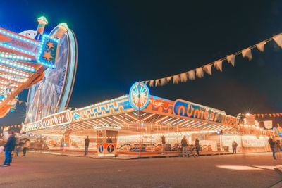 Illuminated ferris wheel at night