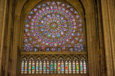 Low angle view of stained glass window in building