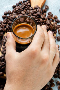 High angle view of hand holding coffee cup