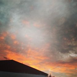 Low angle view of cloudy sky at sunset