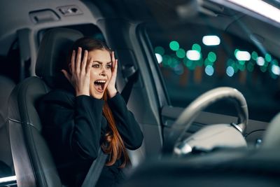 Portrait of young woman in car