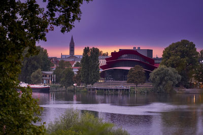 Arch bridge over river against buildings