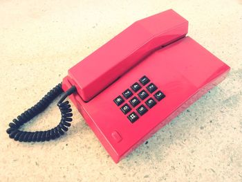 High angle view of telephone booth on table