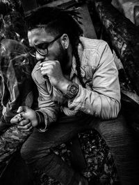 Young man smoking marijuana joint