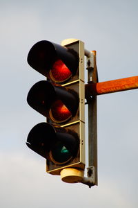 Low angle view of road signal against sky