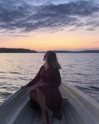 Rear view of woman looking at sea against sky