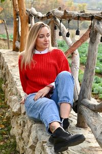 Full length of woman sitting outdoors