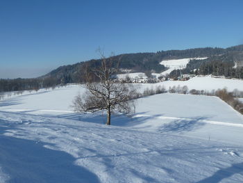 Snow covered landscape against sky