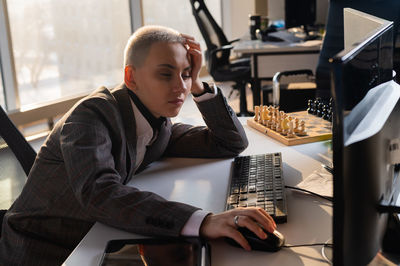 Young man using laptop at office