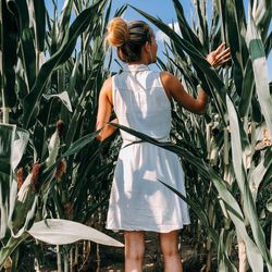 Rear view of woman standing in field