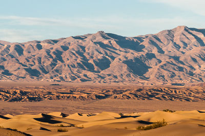 Scenic view of mountains against cloudy sky