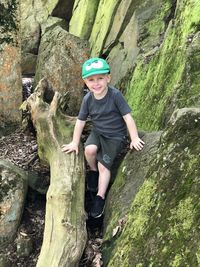 Low section of man sitting on rock