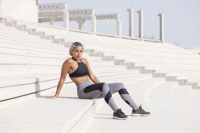 Female athlete sitting on steps