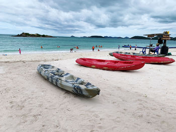 Boats moored on beach against sky