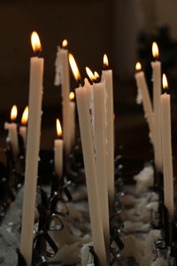 Close-up of lit candles in temple