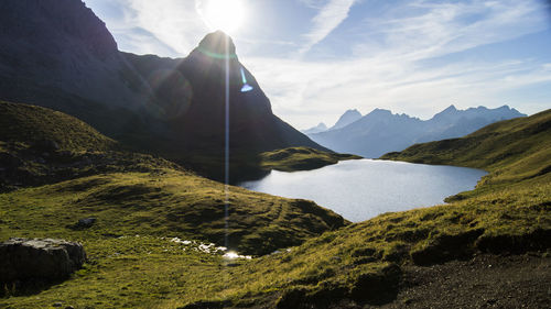 Scenic view of lake and mountains against sky