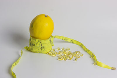 Close-up of yellow fruit against white background