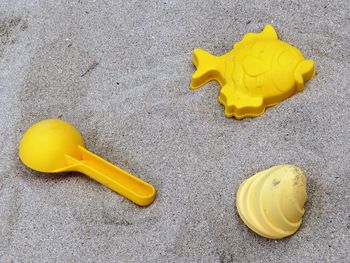 High angle view of yellow leaf on sand